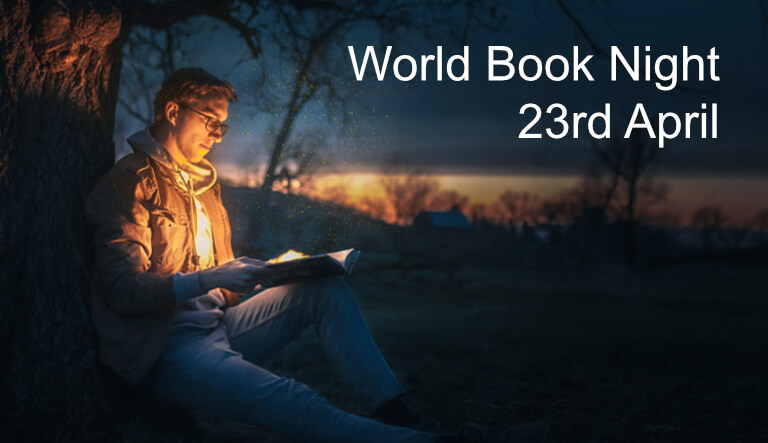 Man reading book at night under tree